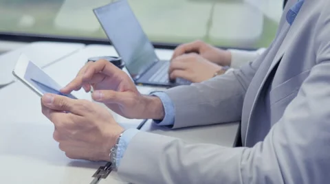 Successful businessman using an app on a white tablet Stock Footage 67262227