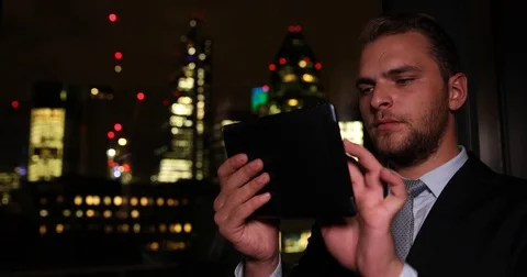 Successful Businessman Using a Digital Tablet Check Brexit Crisis London Skyline Stock Footage 70683481