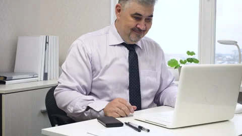 Successful businessman working on computer in office Stock Footage 258608835