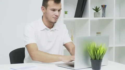 Successful businessman working in the office at the computer Stock Footage 126199253