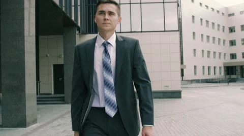 Successful busy businessman signing documents outdoors walking to his office Stock Footage