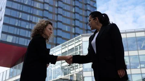Successful close of a deal between two female office workers with a handshake Stock Photos
