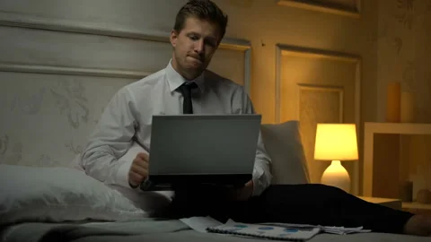 Successful financial expert comparing data in papers and laptop, making report Stock Footage 98146542