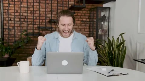 Successful freelancer looks at the computer screen, rejoices and celebrates Stock Footage 236498770