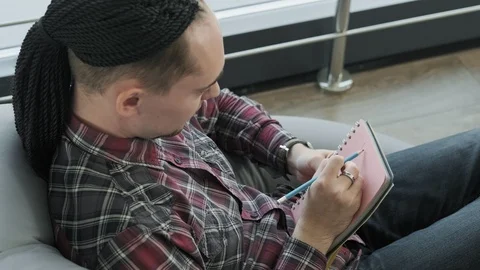 Successful freelancer works making notes in notebook, brainstorming ideas Video stock 115910377