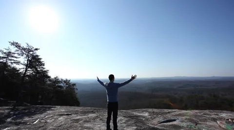 Successful Hiker at the top with arms stretched out Stock Footage 63885953