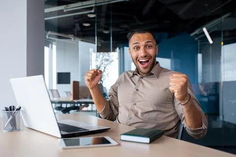 Successful Indian programmer celebrating successful completion of testing new Stock Photos