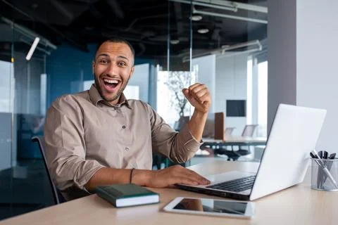 Successful Indian programmer celebrating successful completion of testing new Stock Photos