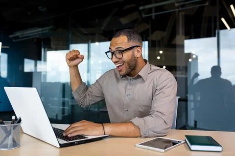 Successful Indian programmer celebrating successful completion of testing new Stock Photos