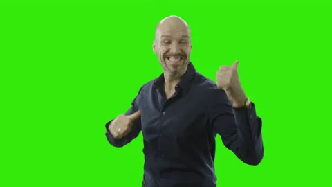 Successful man is cheering at the camera in front of a green screen Stock Footage 166513365