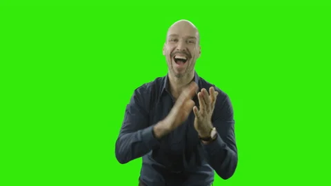 Successful man is cheering at the camera in front of a green screen Stock Footage 166513405