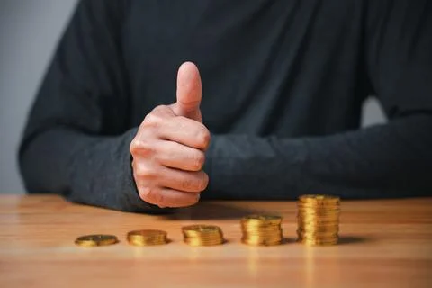 A successful man makes a hand pose with a thumbs up sign gesture of approva.. Stock Photos