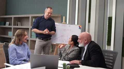 Successful Man presenting his idea to colleagues - creative office workers Stock Footage 246580774