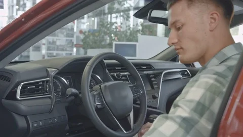 Successful man sitting at the wheel of an expensive car Stock Footage 101110379