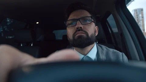 Successful man in a traffic jam. Driver is waiting for a light change Stock Footage 91288005