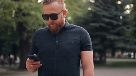 A successful man is using the phone, chatting on the Internet Stock Footage 244245912