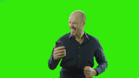 Successful man is waiting for a message and starts cheering at his mobile phone Stock Footage 166513037