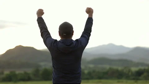 Successful man walking to target and raising arms celebrating at sunset. Stock Footage 158886975
