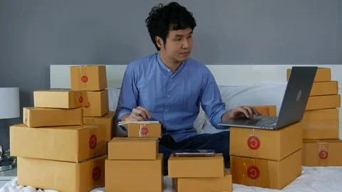 Successful man working and using laptop computer to selling product online Video stock 130104845