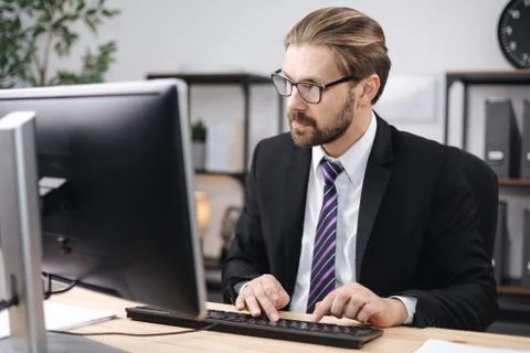 Successful man working on computer at office Stock Photos