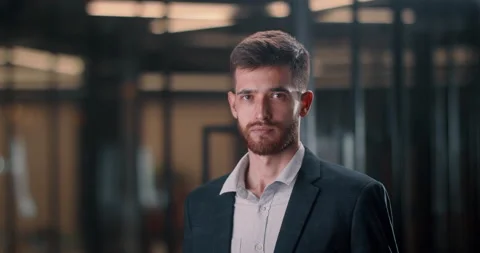 A successful middle manager smiles into the frame. A cinematic shot of a male Stock Footage 222746203