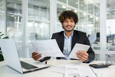 Successful muslim lawyer processing documents while working by portable computer 库存照片