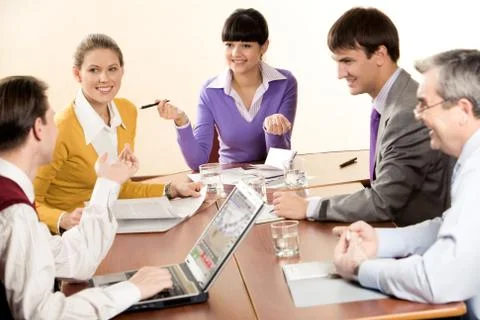 Successful people sharing their methods of management with business partners Stock Photos