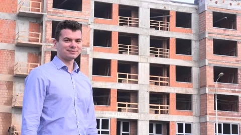 Successful real estate developer showing off his new apartment building project Stock Footage 58513766