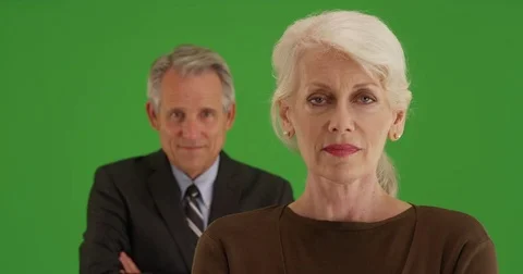 Successful senior businesswoman looking at camera on green screen Stock Footage