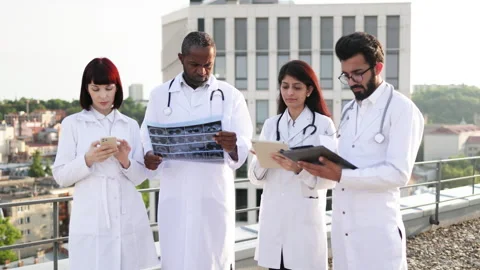 Successful team of multinational doctors in white coats with stethoscopes Stock Footage 262480728