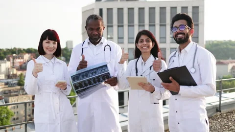 Successful team of multinational doctors in white coats with stethoscopes Stock Footage 262481228