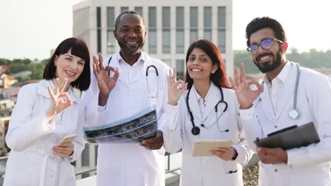 Successful team of multinational doctors in white coats with stethoscopes Stock Footage 262481740