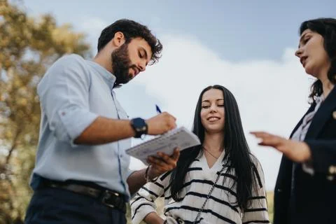 Successful University Students Exchanging Knowledge and Solving Tasks Together Stock Photos