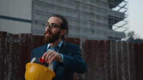 Successful young hipster  builder,  in suit is wearing hard hat and smiling. Stock Footage 119908386