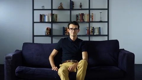 Successful young Man Sitting on the Sofa, Confident eyesight, Looking at the Stock Footage 93260196