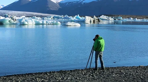 Successful Young Man Using Camera on Tripod Stock Footage 51857539