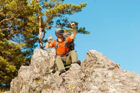 Successful young man, using virtual reality goggles to tour in mountains, on Stock Photos