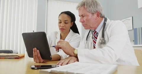 Successfull doctors working on a tablet in the office Video stock 58350579