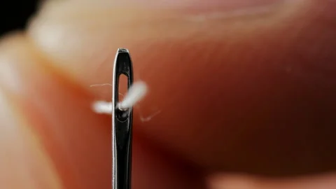 Successfully Threading White Thread In The Eye Of A Needle Video stock 93229921