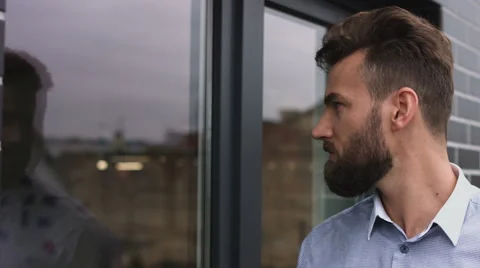 Successsful worker looking at the window and finishing his coffee Stock Footage 68334615