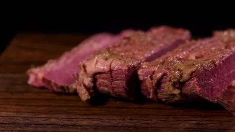 Succulent, mediumrare steak slices on a rustic wooden board, ideal for a gourmet Stock Footage 277423791
