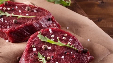 Succulent tender raw lean beef steaks lying Stock Footage 72671709