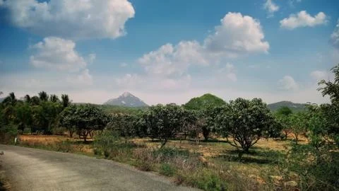 Such a beautiful image covered with tree, mountain, clouds and sky Stock Photos