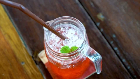 Suck red nectar from the glass Stock Footage 107087947