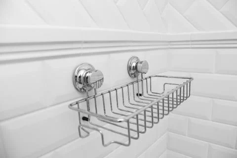Suction cups compact bath shelf, fixing on tiled wall without drilling. Stock Photos