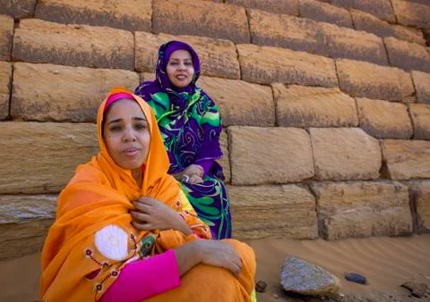 Sudan, Kush, Meroe, sudanese women in front of the pyramids and tombs in roya Stock Photos
