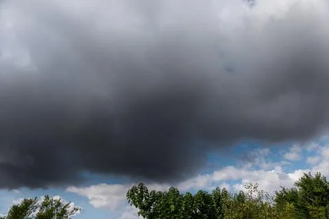 Sudden storm in the summer. Dark clouds. Climate change concept Stock Photos