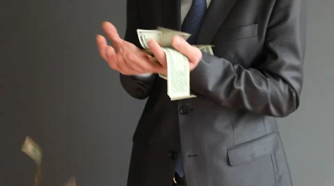 Suddenly falling dollars in businessman's hands Stock Footage 31738680