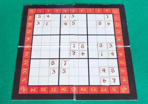 Sudoku board game on green baize table Stock Photos