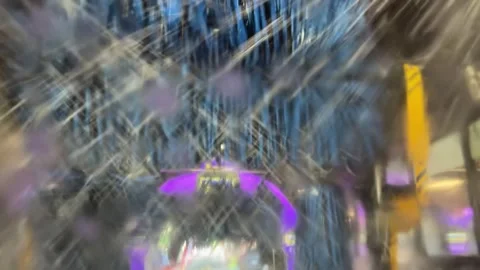 SUDSY WATER PATTERN OF CAR WINDSHIELD ROLLING THRU CAR WASH Stock Footage 336816643